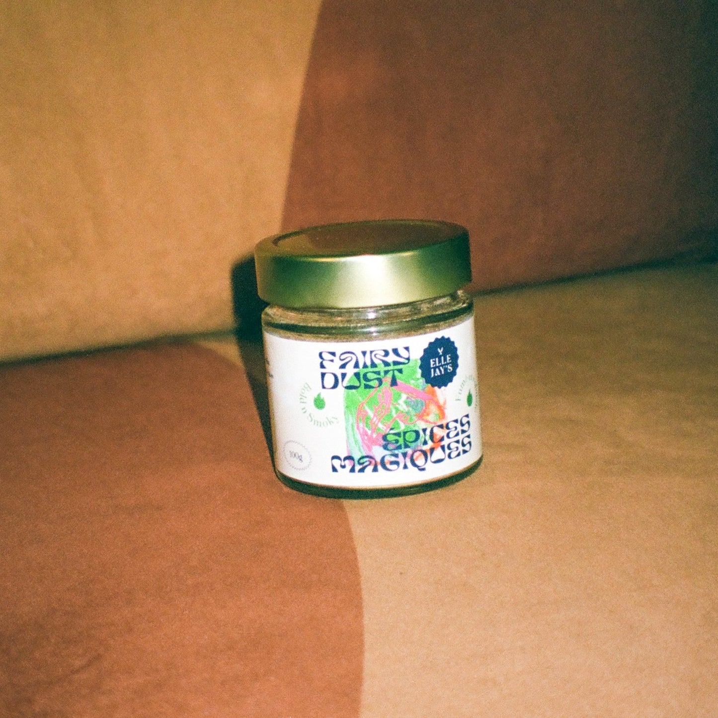 Fairy Dust Bold N Smoky spice jar sitting on a retro 70s chair